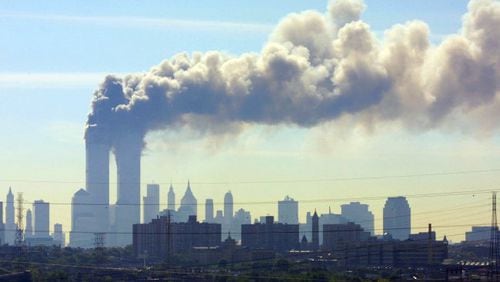 As seen from the New Jersey Turnpike near Kearny, N.J., smoke billows from the twin towers of the World Trade Center in New York after airplanes crashed into both towers Tuesday, Sept.11, 2001. (AP Photo/Gene Boyars)