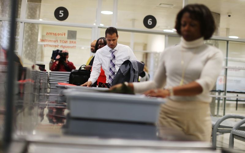 Nov. 23, 2015 - Atlanta - Airport employees make their way through security in a timed test to show how possession of prohibited items delays the line. TSA personnel demonstrated how they respond to prohibited items at security checkpoints in a session for the press using airport employees playing the part of passengers. The Transportation Security Administration is advising travelers to keep prohibited items out of their bags to keep security lines moving. At Hartsfield-Jackson Atlanta International Airport, more than 130 people have been caught with guns at airport security checkpoints so far this year. Whenever a gun, explosive or other dangerous weapons are caught at checkpoints, TSA officers halt security screening in the lane and call Atlanta police to respond to the checkpoint. BOB ANDRES / BANDRES@AJC.COM