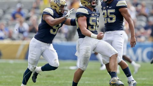 Pittsburgh linebacker Quintin Wirginis, center celebrates with linebackers Saleem Brightwell (9) and Elijah Zeise (25) after sacking Georgia Tech quarterback TaQuon Marshall in the second quarter of an NCAA football game, Saturday, Sept. 15, 2018, in Pittsburgh. (AP Photo/Keith Srakocic)