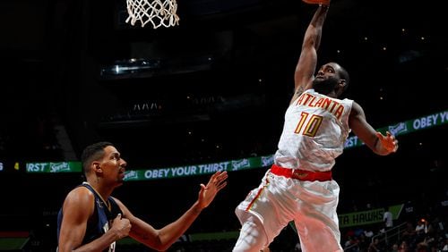 Tim Hardaway Jr. of the Hawks dunks against Alexis Ajinca of the Pelicans at Philips Arena on October 18, 2016 in Atlanta, Georgia. (Photo by Kevin C. Cox/Getty Images)