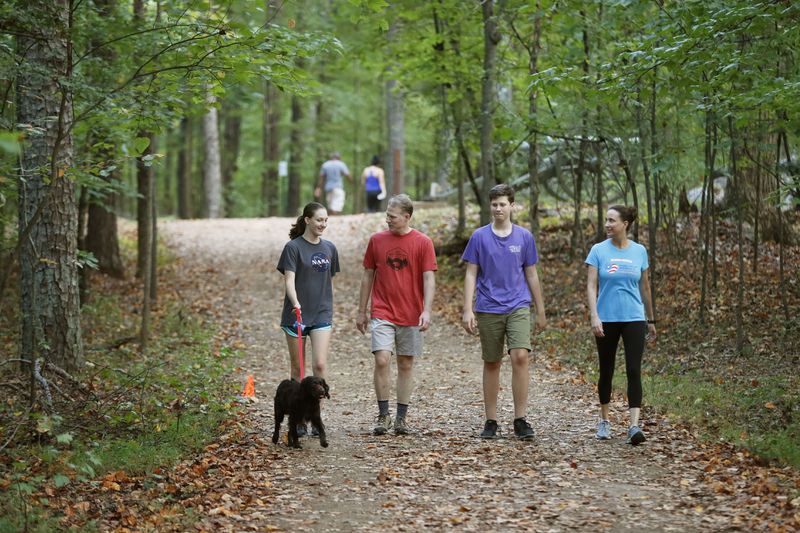 Karla Jacobs (right) goes on a family hike in with her daughter, Abby (from left), husband, Stephen, and son, Daniel, along Kennesaw Mountain National Battlefield Park trails near her home.  Bob Andres / robert.andres@ajc.com