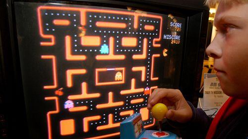 In this Oct. 5, 2004, file photo, Jake Gautney, 12, of Chappaqua, N.Y., tries a Ms. Pac-Man game at the Toy Industry Association holiday preview in New York. Masaya Nakamura, the "Father of Pac-Man" who founded the Japanese video game company behind the hit creature-gobbling game, died on Jan. 22, 2017. He was 91.