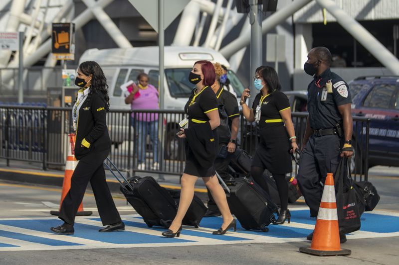 Spirit Air Lines employees make their way into the domestic terminal at Hartsfield-Jackson Atlanta International Airport, Friday, September 4, 2020. (Alyssa Pointer / Alyssa.Pointer@ajc.com)