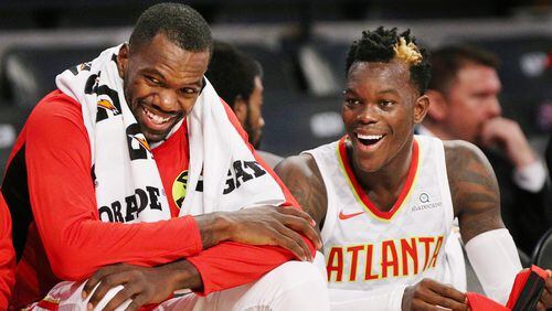 Hawks Dewayne Dedmon (left) and Dennis Schroder share a laugh on the bench against the Grizzlies during the first half in a NBA preseason basketball game on Monday, October 9, 2017, in Atlanta.   Curtis Compton/ccompton@ajc.com