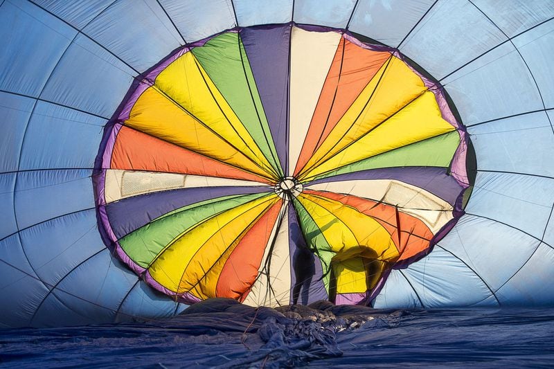 A hot air balloon is inflated with cold air at Piedmont Park in Atlanta, Thursday, August 1, 2019. The Atlanta Balloon Glow event, which is said to feature more than 10 tethered hot air balloons for rides, is set for August 1 through August 4. Weather often forces the balloons to be grounded. ALYSSA POINTER / ALYSSA.POINTER@AJC.COM
