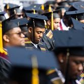 A member of the Morehouse College Class of 2023 bows his head in prayer during the evocation during the Morehouse College commencement ceremony on Sunday, May 21, 2023, on Century Campus in Atlanta. The graduation marked Morehouse College's 139th commencement program. (Christina Matacotta for The Atlanta Journal-Constitution)