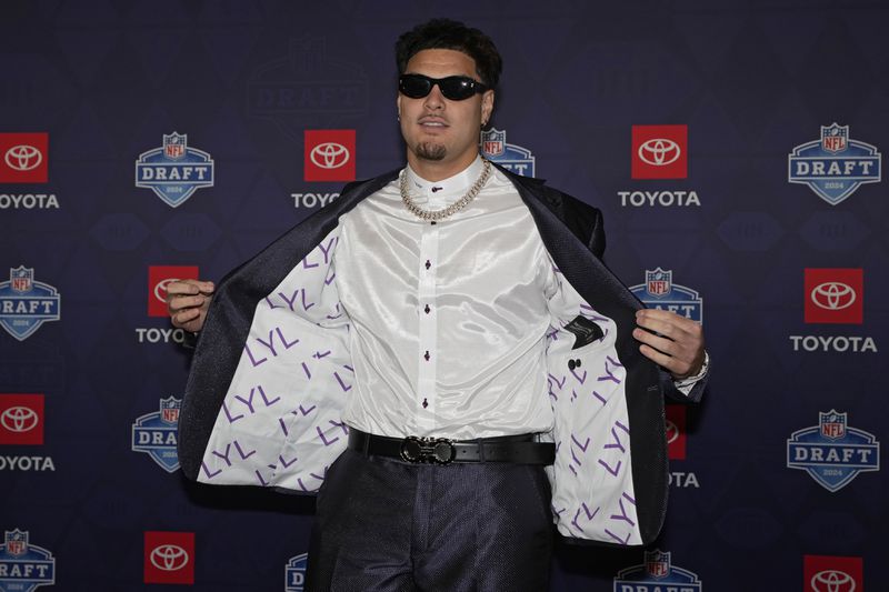 UCLA edge rusher Laiatu Latu poses on the red carpet ahead of the first round of the NFL football draft, Thursday, April 25, 2024, in Detroit. (AP Photo/Carlos Osorio)
