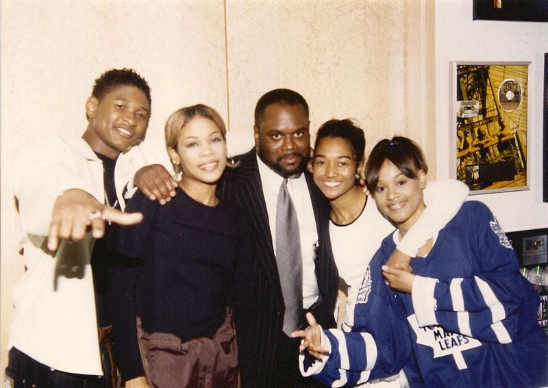LaFace Records artists Usher (left) and TLC pose with label head L.A. Reid in the Atlanta office in 1995.
(Courtesy of Sheri Riley)