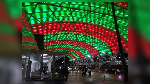 Red and green lights illuminate the canopy at Hartsfield-Jackson International Airport Terminal South on Christmas Eve. A passenger died Tuesday on an inbound flight from Las Vegas, according to police.