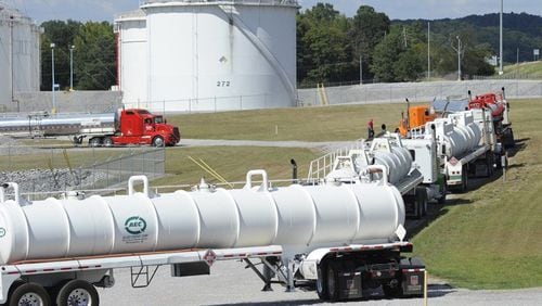 Tanker trucks line up at a Colonial Pipeline facility in Pelham, Ala. The Alpharetta company’s 5,500-mile network is the nation’s biggest. (AP Photo/Jay Reeves)