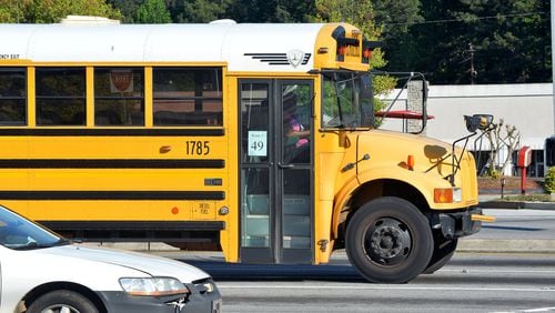 A DeKalb County school bus sits in traffic at Memorial Drive and Hairston Road.
