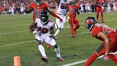 Atlanta Falcons wide receiver Taylor Gabriel (18) runs past Tampa Bay Buccaneers cornerback Brent Grimes, right, for a 9-yard touchdown during the first half of an NFL football game in Tampa, Fla., Thursday, Nov. 3, 2016. (AP Photo/Jason Behnken)