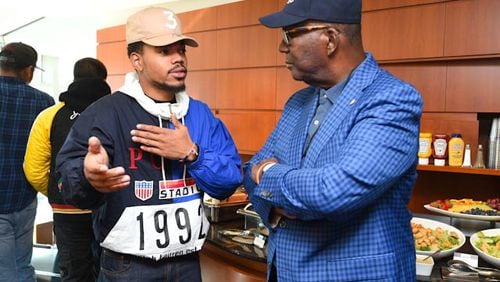Chance the Rapper talks to President Ronald Johnson of Clark Atlanta University. Chance tweeted in August he was interested in attending the Atlanta HBCU, which invited him to attend the CAU football game in Chicago, where Chance grew up.