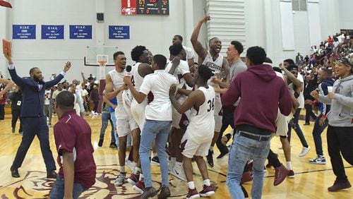 Morehouse players and coaches celebrate their 72-67 victory over Clark Atlanta on Thursday, February 22, 2018. HYOSUB SHIN / HSHIN@AJC.COM