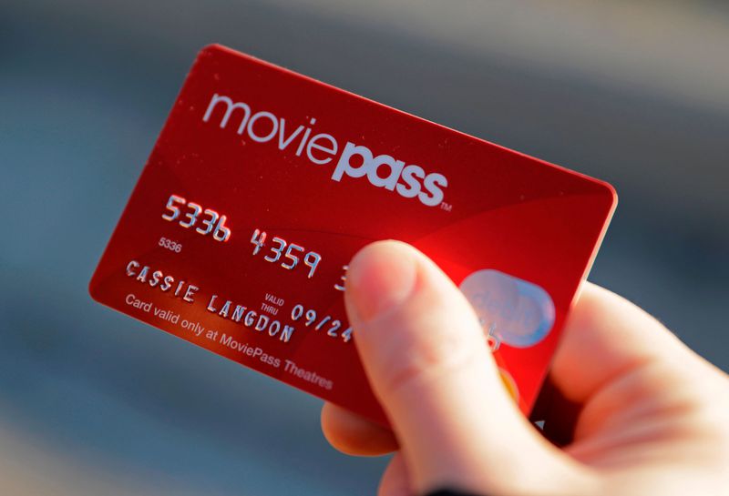 FILE - In this Jan. 30, 2018 file photo, Cassie Langdon holds her MoviePass card outside AMC Indianapolis 17 theatre in Indianapolis. The startup that lets customers watch a movie a day at theaters for just $10 a month, is limiting new customers to just four movies a month. The move comes as customers and industry experts question the sustainability of MoviePass business model. Because MoviePass is paying most theaters the full price of the ticket, the service is in the red with just one or two movies in a month. (AP Photo/Darron Cummings, File) ORG XMIT: NY110