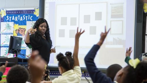 Kindergarten teacher Natalya Almond works with her students in front of a Promethean board at Narvie Harris Elementary School Thursday, November 2, 2017. STEVE SCHAEFER / SPECIAL TO THE AJC