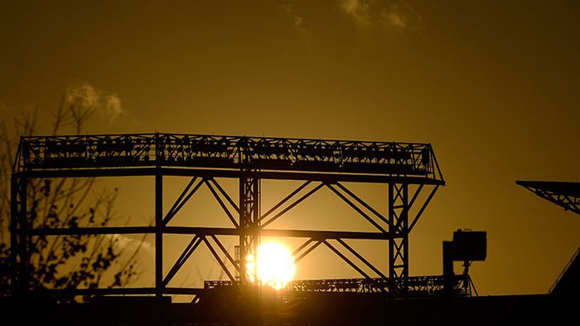 The sun rises over Turner Field after a night of unsettled weather across the South, on Monday, Nov. 24, 2014, in Atlanta.