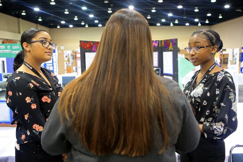Adriana Peguero (left) and Ronia Ufomadu (right) from Archer High School present their project on plant science during the Gwinnett science fair last month. CHRISTINA MATACOTTA for The Atlanta Journal-Constitution