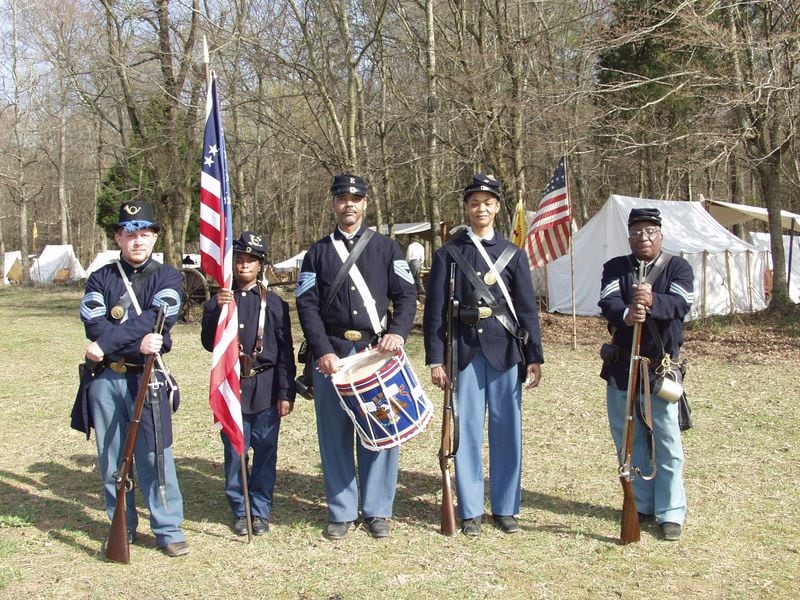 Donald Tatum, center, and friends help keep the memory of the 44th Colored Infantry Regiment alive by reenacting its battles in replica uniforms.