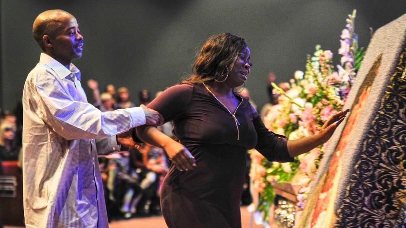 LaTesha Jones, right, is escorted by her father, Dedrick Allen, as she reaches for an image of her daughter, Cor’Dayja Jones, that is imprinted on a blanket during Cor’Dayja’s funeral of at the Redemption Point Church on Saturday in Chattanooga, Tenn. (Lacy Atkins/The Tennessean via AP)