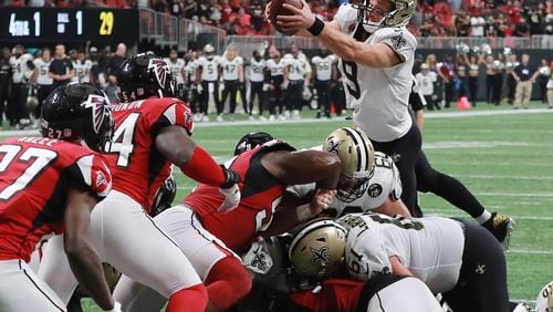 Drew Brees goes over the top for the winning touchdown in overtime to beat the Atlanta Falcons 43-37 on Sunday, Sept 23, 2018, in Atlanta.