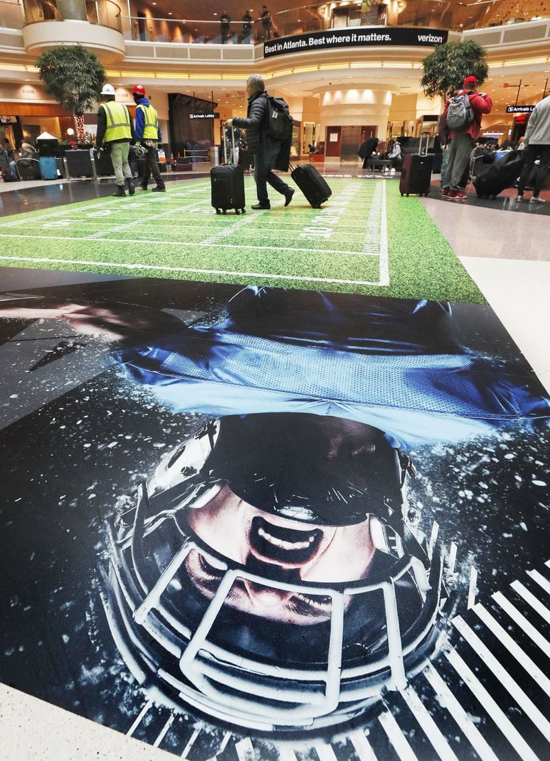 A gridiron is on the floor in the terminal atrium at Hartsfield-Jackson.  Officials say the Super Bowl will mean a 30 percent spike in traffic at Hartsfield Jackson-International Airport, up from the 2,500 flights a day it usually handles.. Bob Andres / bandres@ajc.com