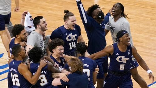 Georgia Tech basketball players celebrate their 80-75 win over Florida State in the ACC championship game Saturday, March 13, 2021, in Greensboro, N.C. (Gerry Broome/AP)