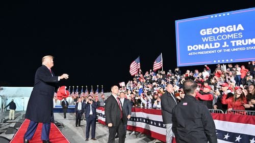 Former President Donald Trump throws hats as he enters the stage during a March 2022 rally for Georgia GOP candidates at Banks County Dragway in Commerce. A new University of Georgia poll of Republican voters shows Trump with 51% support from respondents to lead a field of possible GOP presidential candidates in 2024. Florida Gov. Ron DeSantis placed second at 30%, making him the only other potential hopeful to finish in double digits. (Hyosub Shin / Hyosub.Shin@ajc.com)