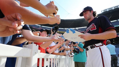 Braves fans get autographs from shortstop Dansby Swanson before a game at Turner Field. (Curtis Compton/ccompton@ajc.com)