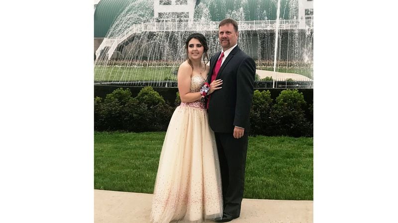 In this Saturday, May 19, 2018, photo provided by Kelly Brown, James Buchanan High School senior Kaylee Suders and Robert Brown pose for a photo at Green Grove Gardens in Greencastle, Pa. Brown, a Pennsylvania man whose son died a month before the senior prom, escorted Suders, his late son's date to the dance Saturday. Robert Brown says he knew his son would've still wanted Suders to go to the prom. Suders says she didn't want to attend after Carter's death but changed her mind when his father asked to accompany her instead.