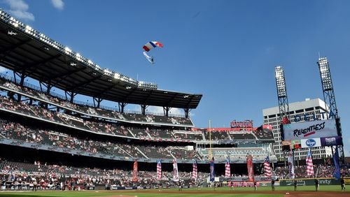 Military personnel drop into the stadium via parachute before the Atlanta Braves game against the St. Louis Cardinals in Game 1 at SunTrust Park on Thursday, October 3, 2019 in Atlanta. (Hyosub Shin / Hyosub.Shin@ajc.com)