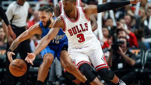 Chicago Bulls guard Dwyane Wade, right, battles for the ball with Orlando Magic guard Evan Fournier, left, during the second half of an NBA basketball game, Monday, Nov. 7, 2016, in Chicago. (AP Photo/Kamil Krzaczynski)