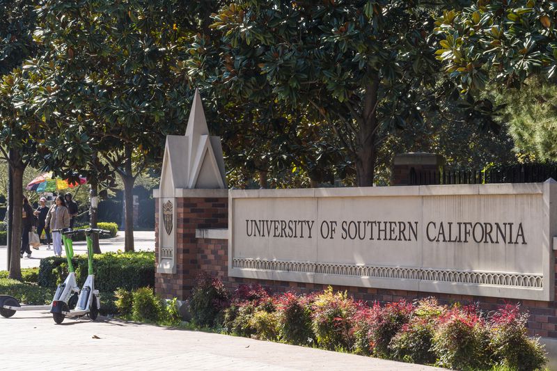 The name for the University of Southern California is displayed at a campus entrance in Los Angeles Tuesday, April 16, 2024.University of Southern California officials have canceled a commencement speech by its 2024 valedictorian, a pro-Palestinian Muslim, citing "substantial risks relating to security and disruption" of the event that draws 65,000 people to campus. (AP Photo/Damian Dovarganes)