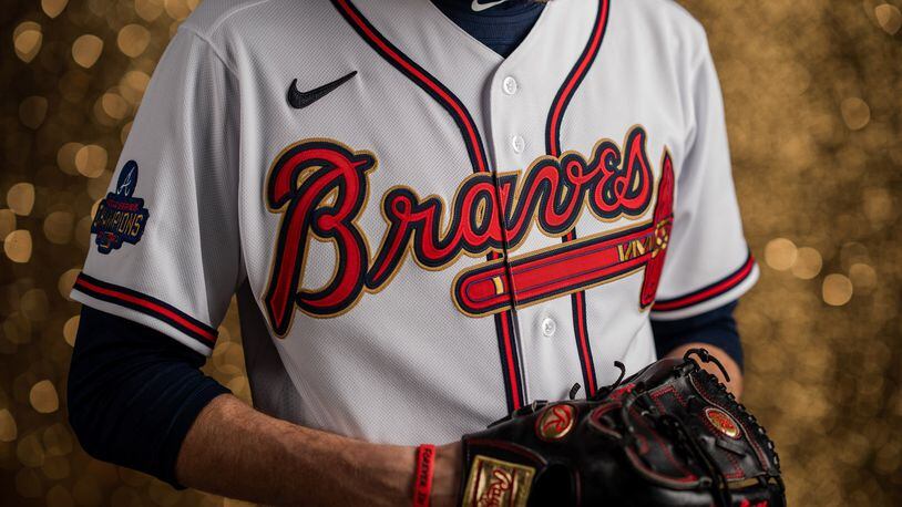 The jerseys for the season's first homestand include gold outlines around the "Braves" script and tomahawk and a World Series Champions patch on the right sleeve with the word CHAMPIONS capitalized in gold.