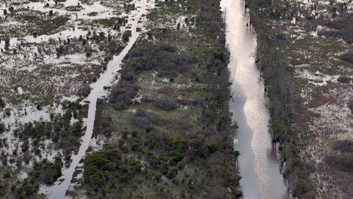 Drone photograph shows Suwannee Canal (right) and Day Use Canoe Trail (left) in the Okefenokee Swamp, Monday, Mar. 18, 2024, in Folkston. Last month, the Georgia Environmental Protection Division (EPD) released draft permits to Twin Pines Minerals for a 584-acre mine that would extract titanium and other minerals from atop the ancient sand dunes on the swamp’s eastern border, which holds water in the refuge. (Hyosub Shin / Hyosub.Shin@ajc.com)