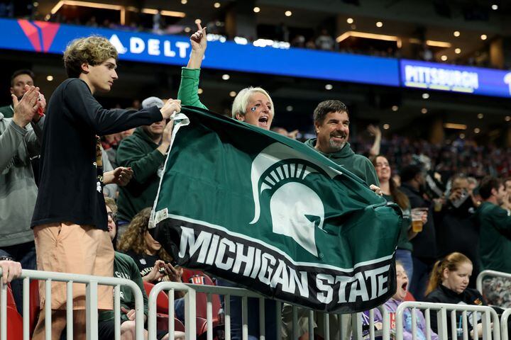 Michigan State Spartans fans celebrate a touchdown during the first half against the Pittsburgh Panthers in the Chick-fil-A Peach Bowl at Mercedes-Benz Stadium in Atlanta, Thursday, December 30, 2021. JASON GETZ FOR THE ATLANTA JOURNAL-CONSTITUTION