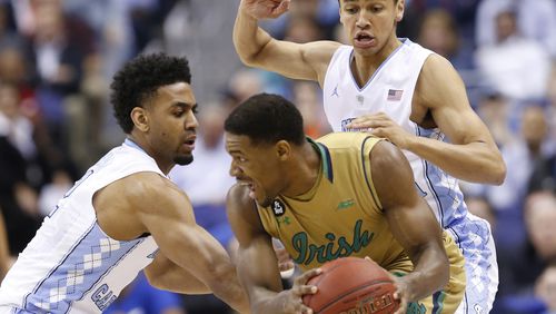 CORRECTS NOTRE DAME PLAYER TO DEMTRIUS JACKSON, INSTEAD OF BRICE JOHNSON - North Carolina's Joel Berry II, left, and Marcus Paige, right, pressure Notre Dame forward Demtrius Jackson during the first half of an NCAA college basketball game in the Atlantic Coast Conference men's tournament, Friday, March 11, 2016, in Washington. (AP Photo/Steve Helber)