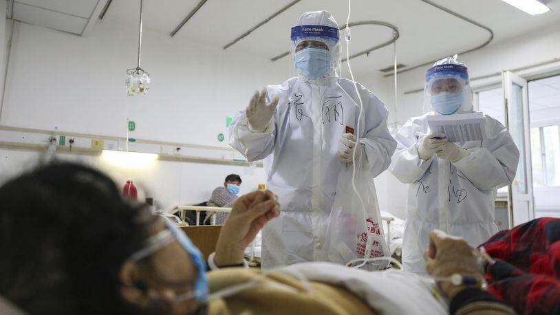 The economic impact of the coronavirus is impossible to predict, but the effect is nearly certain to slow growth, said Rajeev Dhawan, director of the Economic Forecasting Center at Georgia State University. Here, medical workers check on patients in Jinyintan Hospital in Wuhan, China, where the virus was first reported. (Chinatopix Via AP)