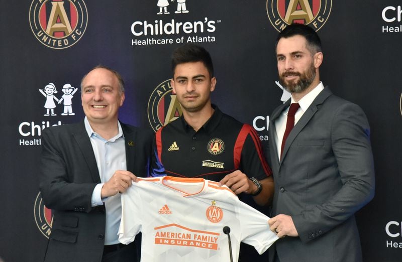 Atlanta United president Darren Eales (left) and vice president and Technical Director Carlos Bocanegra (right) introduce Gonzalo "Pity" Martinez (center) during a press conference Friday, Jan. 25, 2019, at the Children's Healthcare of Atlanta Training Ground in Marietta.
