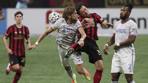 Atlanta United forward Erick Torres collides with FC Cincinnati defender Tom Pettersson on a header while Kendall Watson, right, looks on in an MLS match on Sunday, Nov 1, 2020, in Atlanta.