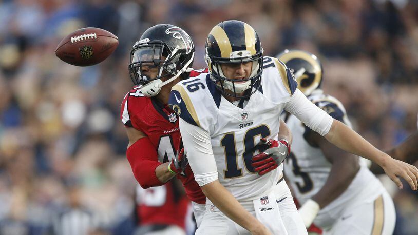 Falcons linebacker Vic Beasley Jr. strips the ball from Rams quarterback Jared Goff, subsequently returning the fumble for a third quarter touchdown at the Coliseum Sunday, Dec. 11, 2016 in Los Angeles. The Falcons won 42-14.  (Robert Gauthier/Los Angeles Times/TNS)