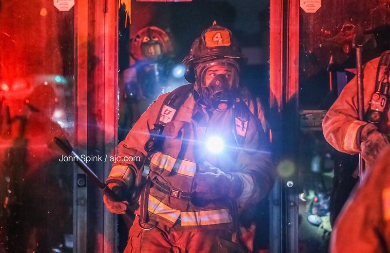 An Atlanta firefighter emerges from the charred remains of the former Gospel Tabernacle Church on Clifton Street. The abandoned building was heavily damaged by a fire Friday morning.