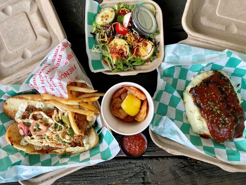 Some of the takeout offerings from LLoyd’s Restaurant & Lounge: fish sandwich with fries, dinner salad, shrimp cocktail, and meatloaf with mashed potatoes. Wendell Brock for The Atlanta Journal-Constitution
