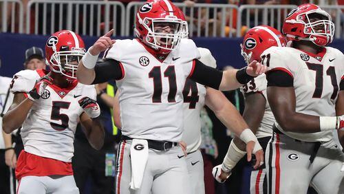Bulldogs quarterback Jake Fromm (11) celebrates a late touchdown over Auburn  during Saturday's SEC Championship  Game.  (Curtis Compton / ccompton@ajc.com)