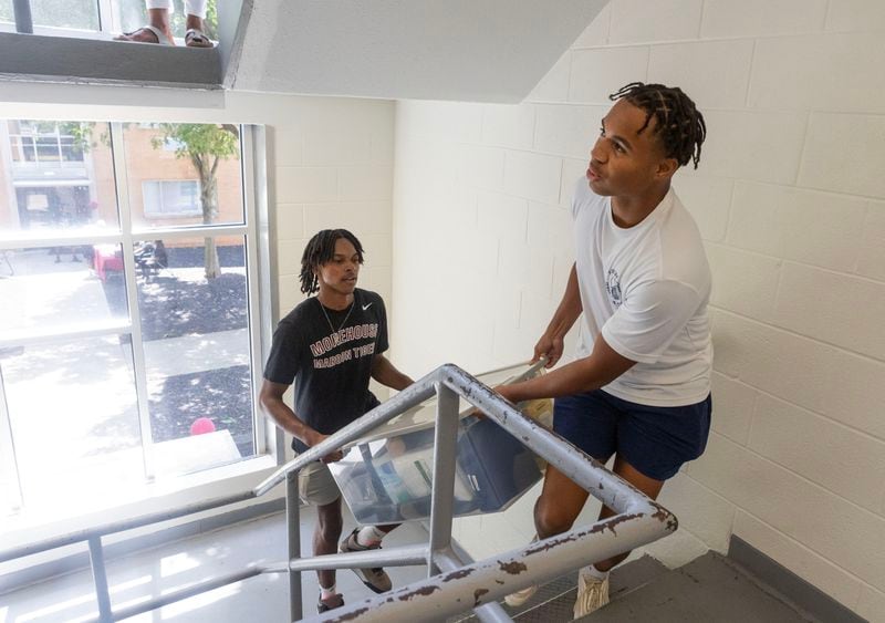 Colin Vaughn (left), from New Jersey, and Will Sears (right), from New York, move their belongings into their Hubert Hall dorm room at Morehouse College in Atlanta on Wednesday, Aug. 9, 2023. (Michael Blackshire/Michael.blackshire@ajc.com)