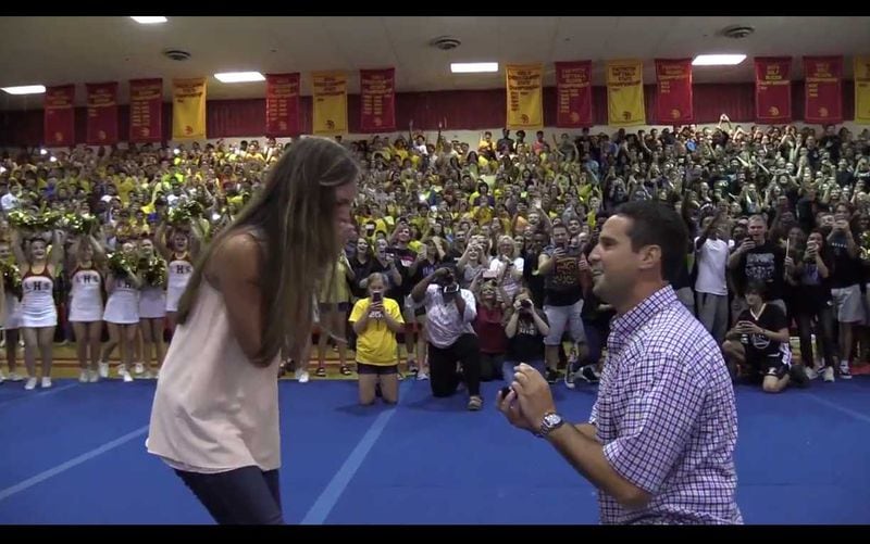 Robbie Galvin, history teacher at Lassiter High School in Marietta, proposes to his girlfriend Sydney Wright at a pep rally on Aug. 25, 2017.