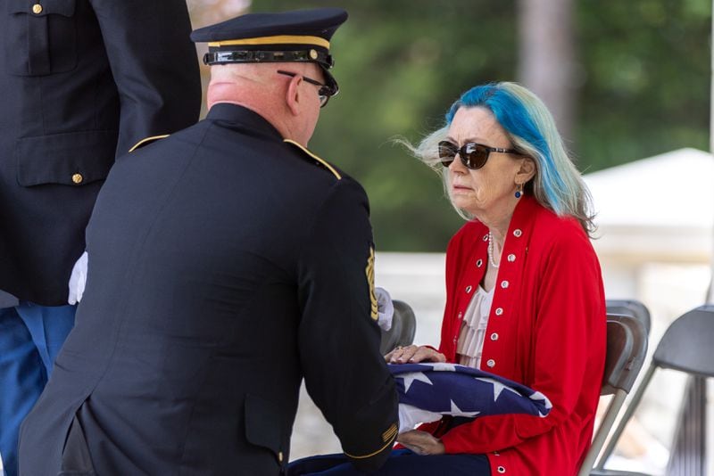 A military official presents a flag to Medal of Honor recipient Luther Story’s niece Judy Wade. Story was reintered with military honors at Andersonville National Cemetery on Memorial Day, Monday, May 29, 2023. The Korean War hero was initially unidentified and buried as an unknown soldier at the National Memorial Cemetery of the Pacific in Honolulu. (Arvin Temkar/The Atlanta Journal-Constitution)