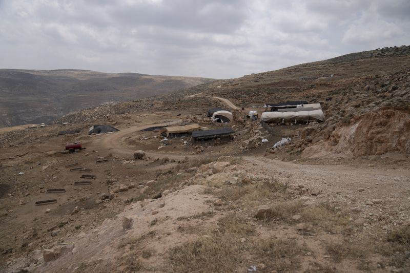 A Bedouin man fled his home on the far hillside seen in the background following a wave of attacks by Israeli settlers, Tuesday, April 30, 2024. (AP Photo/Nasser Nasser)