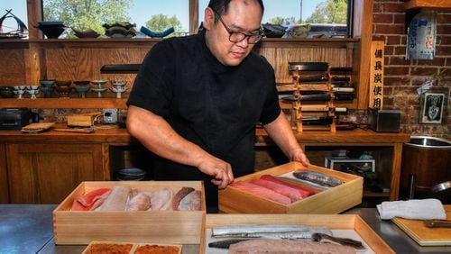 Chef Leonard Yu prepares neta boxes that display the fish for guests and keep it chilled prior to dinner service at his Decatur pop-up, Omakase Table.  (CHRIS HUNT FOR THE ATLANTA JOURNAL-CONSTITUTION)