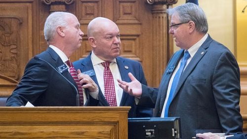 Senate Pro Tem Butch Miller, from left, Senate Majority Leader Mike Dugan and Senate Minority Leader Steve Henson discuss changes to the state Senate’s rules Monday during the first day of Georgia’s legislative session for 2019. (ALYSSA POINTER/ALYSSA.POINTER@AJC.COM)